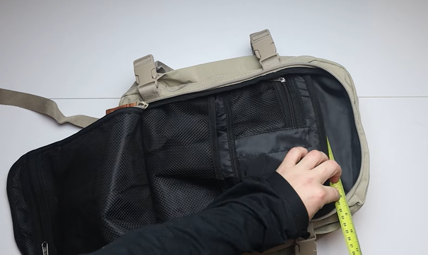Reviewer testing the Cabin Max Metz Stowaway 20L Travel Bag during real-world travel, evaluating packing capacity, comfort, and airline underseat fit.